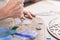 Artist cutting sheets of stained glass into small mosaic squares. Close-up