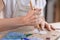 Artist cutting sheets of stained glass into small mosaic squares. Close-up