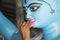 Artist Doing a fine painting job ona a  Clay idols of hindu godess at Kumartuli,Kolkata,India