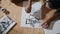 Artist hands painting paper light apartment top view. Guy improving art skills