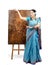 Artist in Indian sari posing with pyrography painting Lotus