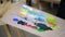 Artist is mixing colours on wooden palette in workshop, close-up view