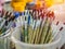 Artist paint brushes. Many artist tools in plastic bucket