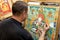 The artist paints a Buddhist icon