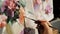 Artist paints oil painting on canvas. Draws flowers