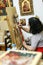 Artist paiting icons in icon painting studio in Kalabaka, Greece