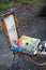 The artist`s palette with brushes in a box is on the street, ready to work. Selective focus