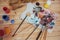 The artist\'s palette. Colored oil paints over a pallete on a table.