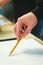 Artist sketches a pencil in a school of painting, preparing a blank canvas for the creation of a painting.