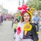 An artist of a theatrical group in a carnival costume takes part in a festive procession of high school graduates