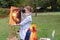 Artist woman holds painting and looks at it, posing at camera an