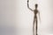 An artist wooden model standing up waving it`s hand.  Shot through a semi transparent material. Creating a textured, blurred