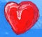 Artistc red heart on light blue background