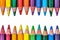 Artistic arrangement crayons form a colorful border on a white surface