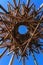 Artistic bamboo circular sculpture against blue sky
