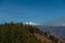 Artistic capture of distant, snow-covered Himalayan glaciers framed by deep valleys and rugged mountain ridges, in Uttarakhand,