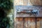 Artistic close up shot of an old iron or steel bolt, on a rustic wooden door