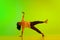 Artistic, flexible, talented young girl, hip-hop dancer performing against gradient green yellow background in neon