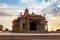 artistic hindu temple with dramatic sunset sky at evening from unique perspective