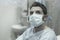 Artistic hospital portrait of attractive and scared man infected by covid19 -  adult male in face mask at clinic suffering