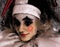 Artistic image of harlequin doll. Beautiful joker girl.