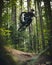 Artistic Mountain Bike Jump Air Framed by Forest Foliage