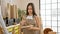 Artistic passion unleashed, young, beautiful hispanic woman artist delightfully drawing at hip art studio, standing clad in apron,