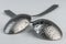 Artistic place setting photo of two spoons with water droplets