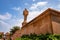 artistic red stone jain god holy pillar with bright blue sky at morning from unique angle