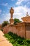 artistic red stone jain god holy pillar with bright blue sky at morning from unique angle