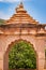 artistic red stone jain temple entrance at morning from unique angle