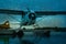 Artistic rendering of a float plane docked in Anchorage Alaska under starry sky