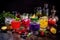 artistic shot of colorful cocktails, with fruit and herbs used as mixers