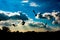 Artistic Silhouette of flying Pigeons with blue sky with white clouds in the background. Uttarakhand India