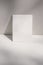 Artistic still life scene. Blank vertical greeting card, poster mockup against beige, nude wall. White table background