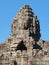 Artistic stone human faces embellishing the towers of the Khmer Bayon Temple