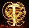 Artists juggling with two flaming poi\'s on fire. Prolonged exposure causes painting with light.