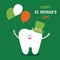 Ð¡artoon tooth in St. Patrick`s hat with balloons colors of the Irish flag on green background.