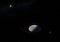 Artwork of Haumea ellipsoidal dwarf planet with rings in the Kuiper belt and its moons HiÊ»iaka and Namaka