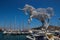 Artwork of a unicorn against a background of yachts and boats in the Mediterranean