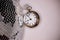 Arty shot of a metal large pocket watch clock next to a silver disco ball