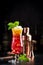 Aruba Ariba alcoholic cocktail drink with vodka, white rum, orange, lemon and pineapple juice, grenadine, dark bar counter
