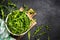 Arugula fresh green leaves at black stone table.