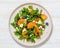 arugula persimmon cheese berries salad, top view