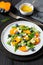 arugula persimmon cheese berries salad, top view