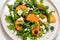 arugula persimmon cheese berries salad, top view