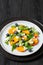 arugula persimmon cheese berries salad, top view