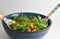 Arugula salad with heirloom tomatoes and lemon dressing in a large mixing bowl.