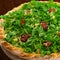 Arugula and sundried tomato pizza