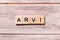 ARVI word written on wood block. ARVI text on wooden table for your desing, coronavirus concept top view
